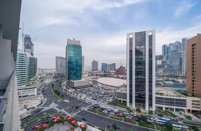 a city with a busy highway in front of tall buildings at Luxury Downtown Studio Pool Marina View in Dubai