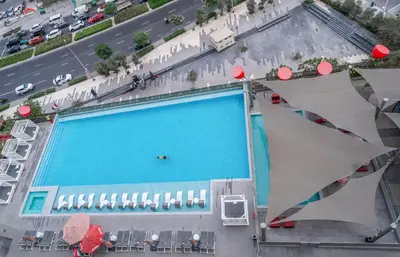 an overhead view of a large swimming pool at Luxury Downtown Studio Pool Marina View in Dubai