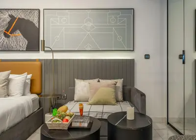 a hotel room with a bed and a table with fruit on it at Luxury Downtown Studio Pool Marina View in Dubai