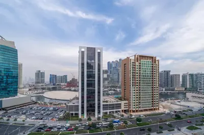 a city skyline with tall buildings and a parking lot at Luxury Downtown Studio Pool Marina View in Dubai
