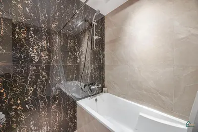 a bathroom with a shower and a bath tub at Spacious & cozy Studio in Downtown! in Sabkhah