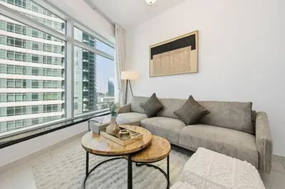 a living room with a couch and a table at Modern 1 Bed in the Heart of Downtown 5 mins walk from Burj Khalifa and Dubai Mall in Dubai