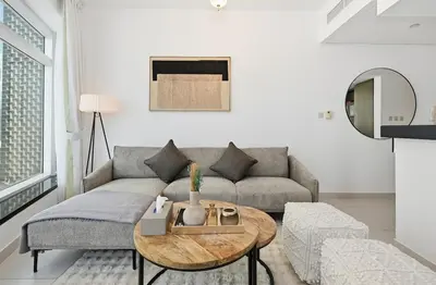 a living room with a couch and a table at Modern 1 Bed in the Heart of Downtown 5 mins walk from Burj Khalifa and Dubai Mall in Dubai
