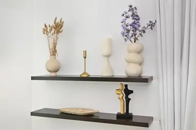 a shelf with vases and candles on a wall at Modern 1 Bed in the Heart of Downtown 5 mins walk from Burj Khalifa and Dubai Mall in Dubai