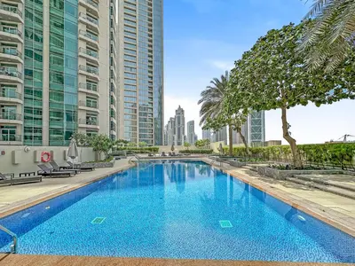 a swimming pool in the middle of a city with tall buildings at Modern 1 Bed in the Heart of Downtown 5 mins walk from Burj Khalifa and Dubai Mall in Dubai