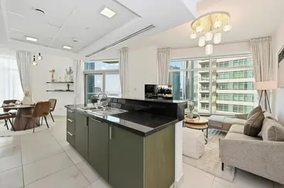 a kitchen and living room with a couch and a table at Modern 1 Bed in the Heart of Downtown 5 mins walk from Burj Khalifa and Dubai Mall in Dubai