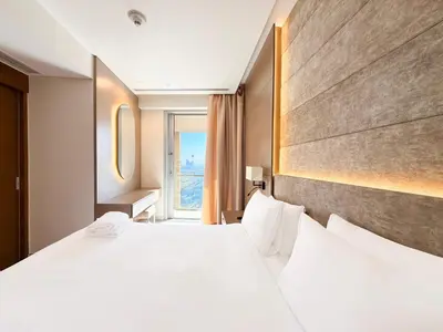 a hotel room with a large bed and a window at Luxurious 1 BR Apt Kempinski Central Avenue in Dubai