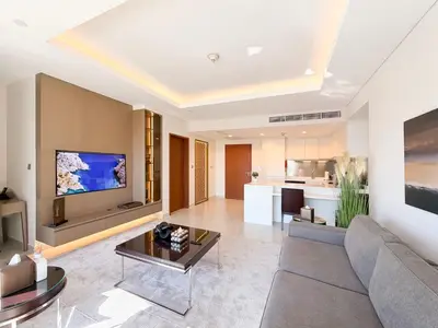 a living room with a couch and a tv at Luxurious 1 BR Apt Kempinski Central Avenue in Dubai