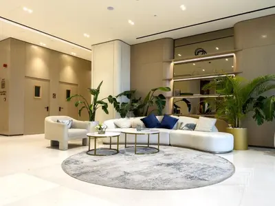 a living room with a white couch and a rug at Brand New Luxe Studio Sauna, Gym&Pool With Access in Dubai