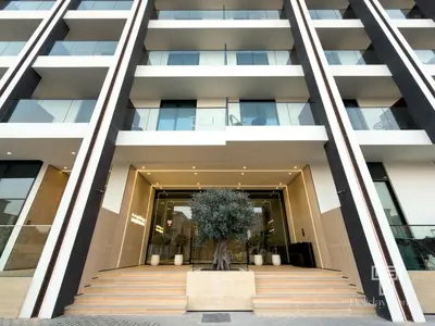 a building with a tree in front of it at Brand New Luxe Studio Sauna, Gym&Pool With Access in Dubai