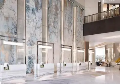 a lobby of a building with columns and a staircase at Dubai Mall Luxury 1Bed The Address in Dubai