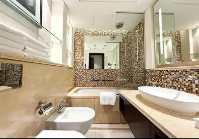 a bathroom with a sink and a toilet and a tub at Dubai Mall Luxury 1Bed The Address in Dubai
