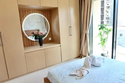 a bedroom with a bed and a mirror at Minteh Holiday Home in Dubai