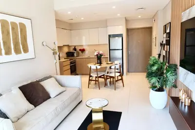 a living room with a couch and a table at Minteh Holiday Home in Dubai