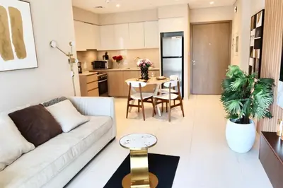 a living room with a couch and a table at Minteh Holiday Home in Dubai