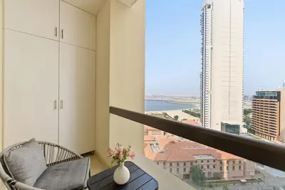 a balcony with a chair and a view of the city at Beachfront Studio JBR - Murjan 2 by Home Of Choice in Dubai