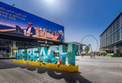 a building with a large sign on the side of it at Beachfront Studio JBR - Murjan 2 by Home Of Choice in Dubai