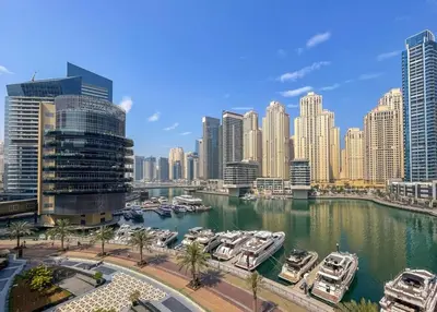 a view of a city with boats in a harbor at Lux Stay In Dubai Marina BCOM in Dubai