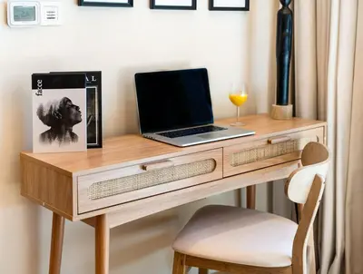 a desk with a laptop and a glass of wine at Lux Stay In Dubai Marina BCOM in Dubai