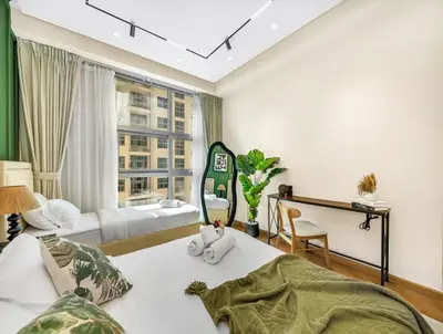 a bedroom with two beds and a window at Lux Stay In Dubai Marina BCOM in Dubai