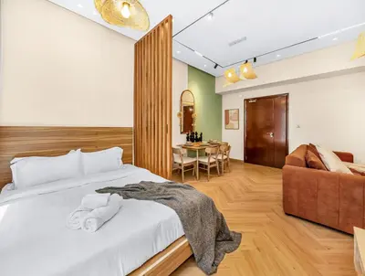 a bedroom with a bed and a chair and a table at Lux Stay In Dubai Marina BCOM in Dubai