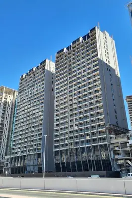 a large building with many windows in a city at 2 BR with Full Burj View 10 min Walk to Dubai Mall in Dubai