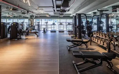 a gym with rows of treadmills and machines at 2 BR with Full Burj View 10 min Walk to Dubai Mall in Dubai