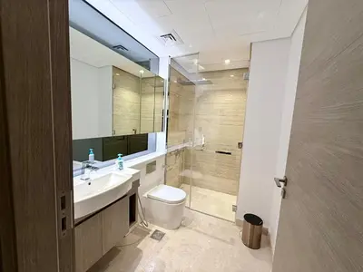 a bathroom with a sink and a toilet and a mirror at 2 BR with Full Burj View 10 min Walk to Dubai Mall in Dubai