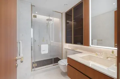 a bathroom with a shower and a toilet and a sink at Ultra Luxury 2BD Beachfront & Panoramic Sea Views in Dubai