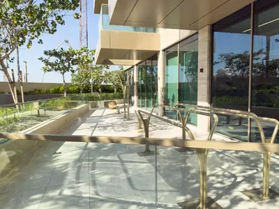 a house with glass walls and a patio at Ultra Luxury 2BD Beachfront & Panoramic Sea Views in Dubai