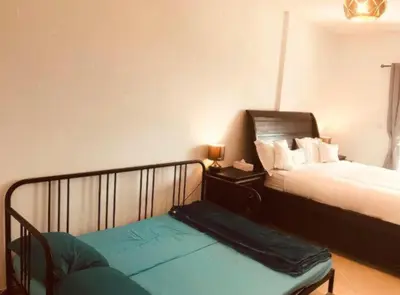 a bedroom with a bed and a bench in it at Royal Marina Inn in Dubai
