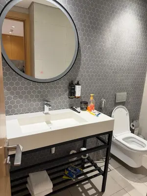 a bathroom with a sink and a mirror and a toilet at A luxurious 1 bedroom and living room in Dubai
