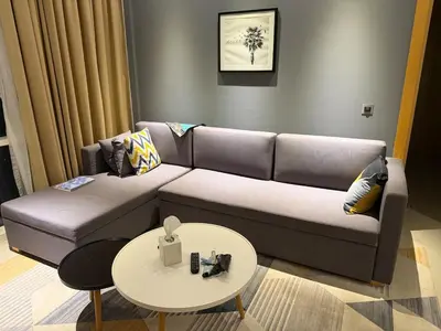 a living room with a couch and a table at A luxurious 1 bedroom and living room in Dubai