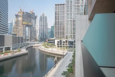 a view of a river in a city with tall buildings at Waterfront Luxe Haven Peninsula in Dubai