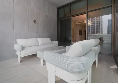a living room with a couch and a chair at Waterfront Luxe Haven Peninsula in Dubai