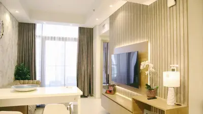a living room with a television and a large window at Stunning 2 Bedroom Aykon City Tower C in Dubai