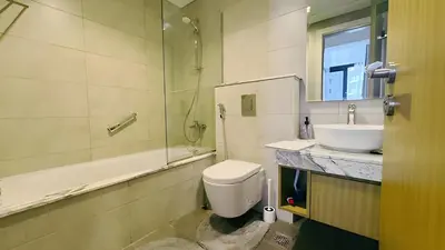 a bathroom with a toilet and a sink and a shower at Stunning 2 Bedroom Aykon City Tower C in Dubai