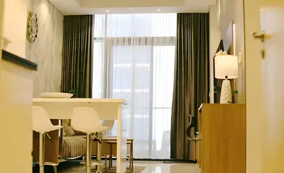 a room with a table and chairs and a window at Stunning 2 Bedroom Aykon City Tower C in Dubai