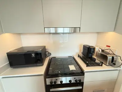 a kitchen with a stove top and a microwave at Luxury 1BR I Creek Beach I Pool & Beach in Dubai