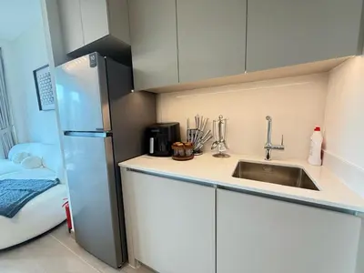 a kitchen with a sink and a refrigerator at Luxury 1BR I Creek Beach I Pool & Beach in Dubai