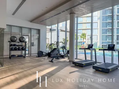a gym with fitness equipment in a building at LUX The Burj Khalifa Lagoon View Suite 5 in Dubai