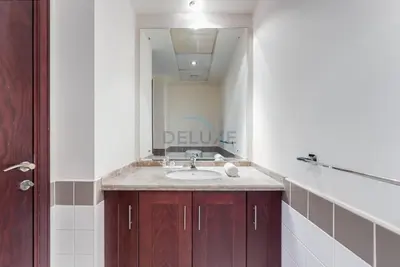 a bathroom with a sink and a large mirror at Serene 2BR Villa, Minutes Drive to Miracle Garden and Dubai Butterfly Garden, Steps from Golf Course, Palmera 2, Arabian Ranches by Deluxe Holiday Homes in Dubai