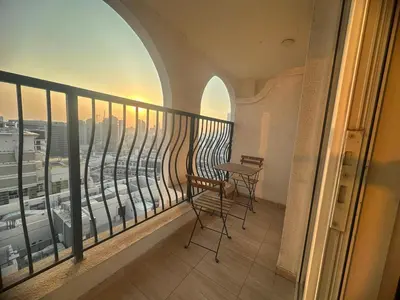 a balcony with a table and chairs in a building at Burj Sabah in Dubai
