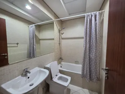 a bathroom with a sink and a toilet and a mirror at Burj Sabah in Dubai