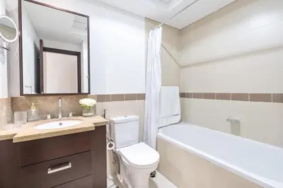a bathroom with a sink and a toilet and a bath tub at Burj Khalifa District Luxury Apartment - Downtown Dubai in Dubai