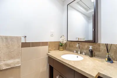 a bathroom with a sink and a mirror at Burj Khalifa District Luxury Apartment - Downtown Dubai in Dubai