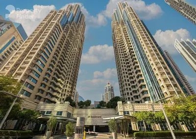 two large tall buildings in a city with trees at Burj Khalifa District Luxury Apartment - Downtown Dubai in Dubai