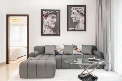 a living room with a couch and a glass table at Burj Khalifa District Luxury Apartment - Downtown Dubai in Dubai