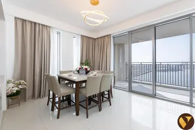 a dining room with a table and chairs at Vogue Creek Harbour Icon Bay Waterfront Living Close to Downtown, Burj Khalifa and Dubai Mall, Three Bedroom Apartment with Large Balcony, Canal and Burj Khalifa View, Access to all Amenities in Dubai