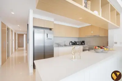 a kitchen with a stainless steel refrigerator and cabinets at Vogue Creek Harbour Icon Bay Waterfront Living Close to Downtown, Burj Khalifa and Dubai Mall, Three Bedroom Apartment with Large Balcony, Canal and Burj Khalifa View, Access to all Amenities in Dubai